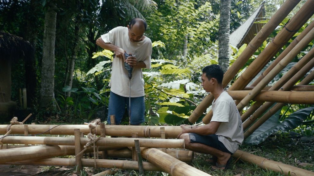 BAMBOO U - Carpenter Working on Bamboo Frame for Roof